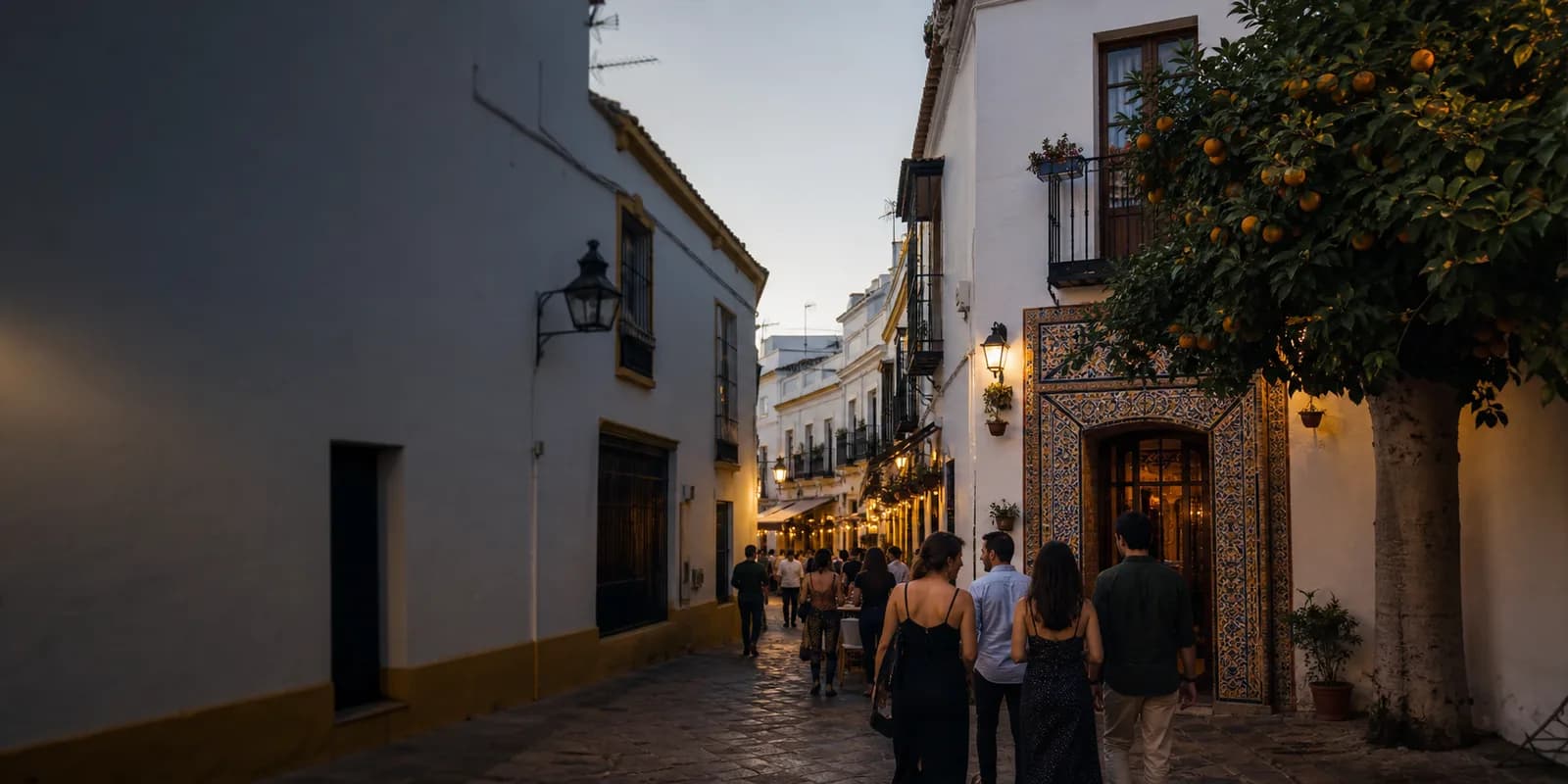 Evening street in Seville with orange trees and small tapas terraces